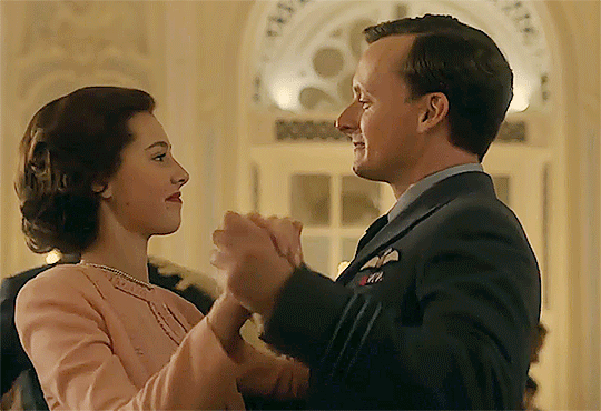 Upstairs, young Princess Margaret dances demurely with young Peter Townsend.