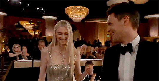 Elizabeth Debicki kisses her partner Kristian Rasmussen and looks back towards friends & co-stars at 'The Crown's' table before heading to the stage to accept her award.